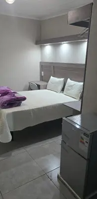 a bedroom with a large bed and a desk at Private 4 Double Room Guest Wing, Comfortable, Secure Parking, Wi-Fi, Ensuite Bath in Ermelo