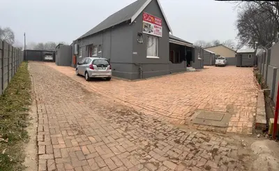 a car parked on a brick driveway next to a building at Private 4 Double Room Guest Wing, Comfortable, Secure Parking, Wi-Fi, Ensuite Bath in Ermelo