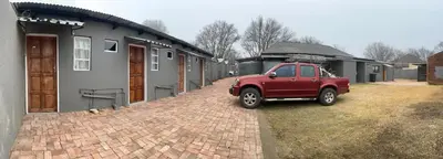 a red truck parked in front of a house at Private 4 Double Room Guest Wing, Comfortable, Secure Parking, Wi-Fi, Ensuite Bath in Ermelo