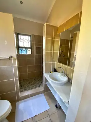 a bathroom with a sink and a toilet and a shower at Park View - Creature comforts in nature in Marloth Park