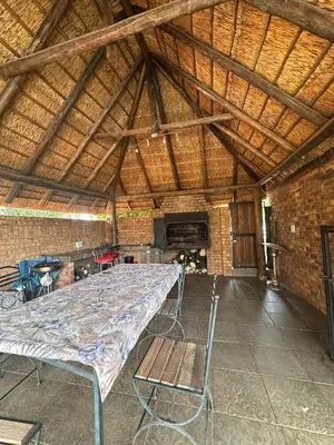 a large room with a bed and a wooden ceiling at Tsheryl's Residence in Centurion