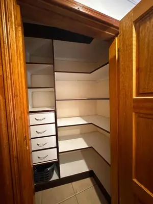 a walk in closet with white drawers and shelves at Tsheryl's Residence in Centurion