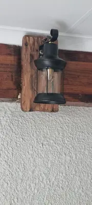a black bell hanging from the ceiling in a room at Cammys in Secunda