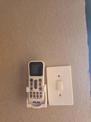 a cell phone and an adapter on a wall at Limpopo LidoSystem Lodge