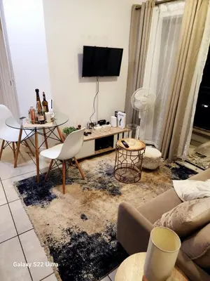 a living room with a couch and a table at WeAreTogetherLuxuryApartment in Pretoria