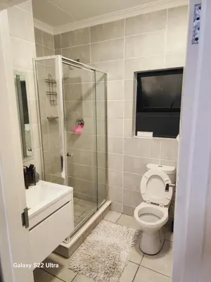 a bathroom with a shower and a toilet and a sink at WeAreTogetherLuxuryApartment in Pretoria