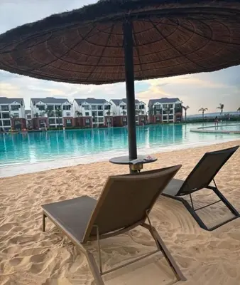 a chair and an umbrella on the beach at WeAreTogetherLuxuryApartment in Pretoria