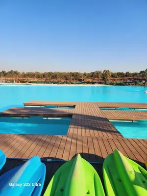 a view of a pool with tables and chairs at WeAreTogetherLuxuryApartment in Pretoria