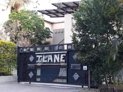 a blue gate with the words fame on it at Ilane Guesthouse in Nelspruit