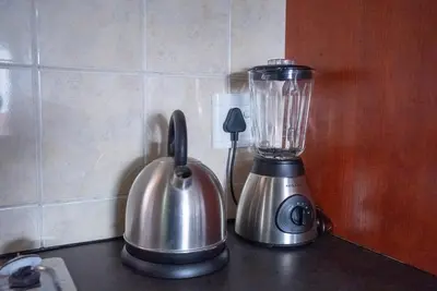 a blender and a tea kettle on a counter at Modern Tranquility in Benoni