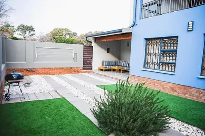a backyard with a bench and a house at Walton Luxe Retreat in Midrand