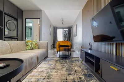 a living room with a couch and a table at The Manson's BishopsCourt in Pretoria