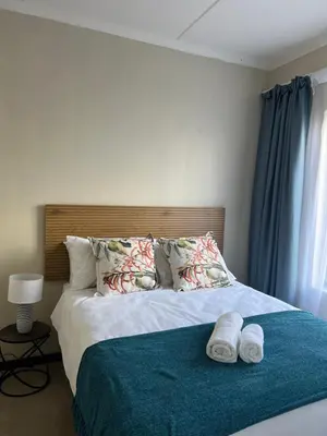 a bedroom with a bed with two towels on it at The West End 252 in Midrand