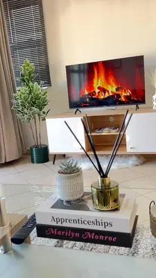 a book sitting on a table with a fireplace at Luxury Lakeview Retreat in Pretoria