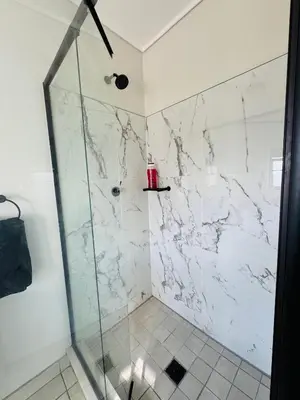 a bathroom with a shower with a glass door at Shezi Cozy Home at The Blyde in Pretoria