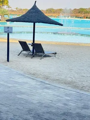 two chairs under an umbrella on a beach at Shezi Cozy Home at The Blyde in Pretoria