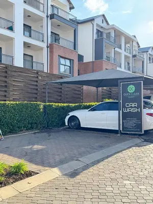 a white car parked under an umbrella next to a building at Shezi Cozy Home at The Blyde in Pretoria