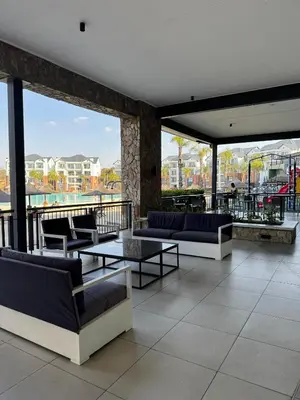 a lobby with couches and tables on a building at Shezi Cozy Home at The Blyde in Pretoria