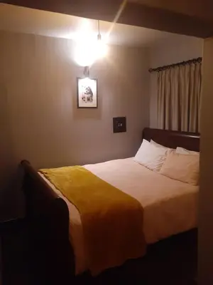 a bedroom with a bed with a yellow blanket at The Concept in Centurion