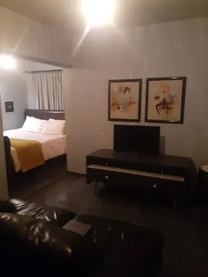 a bedroom with a bed and a desk with a television at The Concept in Centurion