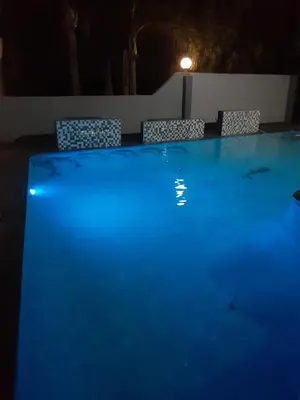 a swimming pool at night with blue lights at The Concept in Centurion