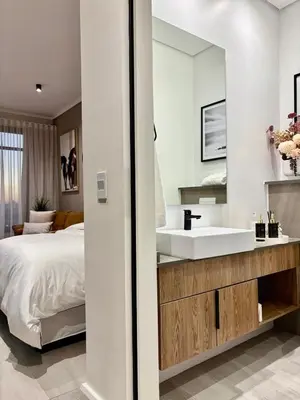 a bedroom with a white sink and a bed at Modern Studio in Menlyn Maine in Pretoria