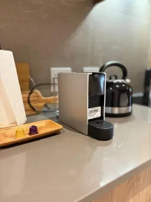 a coffee maker on a counter with a tray of food at Modern Studio in Menlyn Maine in Pretoria