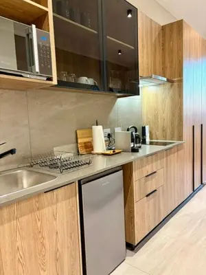 a kitchen with a sink and a counter top at Modern Studio in Menlyn Maine in Pretoria