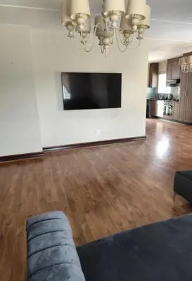 a living room with a couch and a flat screen tv at Aspen Creek in Benoni