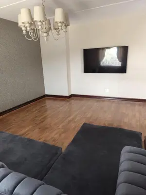 a living room with a couch and a flat screen tv at Aspen Creek in Benoni