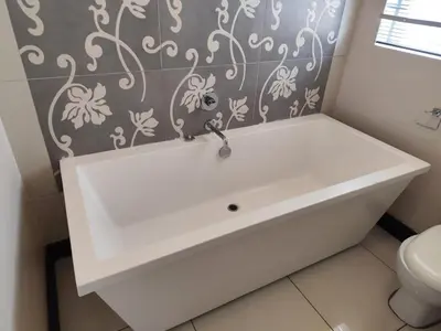 a white sink in a bathroom with a toilet at Aspen Creek in Benoni