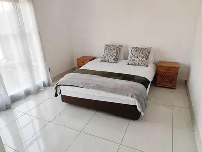 a bedroom with a bed with two pillows on it at Doringdraad Lodge Rooms Mufasa and Simba in Brendan Village