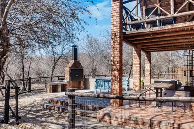 a brick building with a fireplace in a park at Timbuktwini, Marloth Park, Mpumalanga in Marloth Park