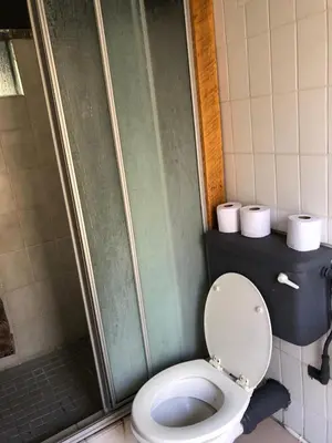 a bathroom with a toilet and a shower at Doringdraad Lodge Nala and Zazu in Brendan Village