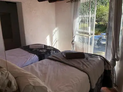 two beds in a room with a window at Doringdraad Lodge Nala and Zazu in Brendan Village