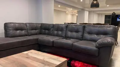 a brown leather couch in a living room at Yinjwasi Hill guest house in Armburg