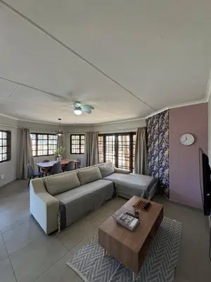 a living room with a couch and a table at Around the corner in Pretoria