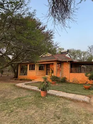 a brick house with a tree in front of it at Around the corner in Pretoria