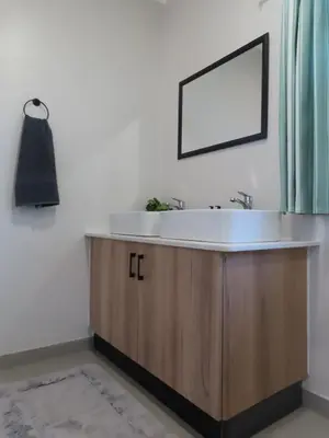 a bathroom with a sink and a mirror at Around the corner in Pretoria