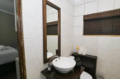 a bathroom with a sink and a mirror at Morning Star Guest House in Kempton Park