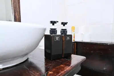 a white bowl and two bottles on a counter at Morning Star Guest House in Kempton Park