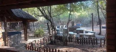 a view of a playground with tables and a fence at Martys Place in Marloth Park
