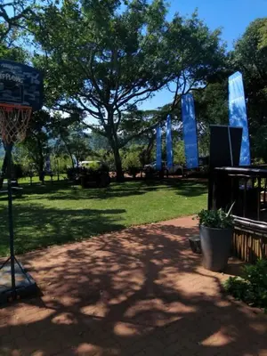 a basketball hoop in a park with a tree at Harnham Mountain Lodge in Elsteg