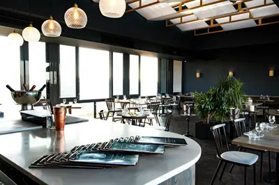 a restaurant with a bar with tables and chairs at Menlyn Maine Trilogy Apartment in Pretoria