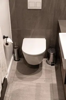 a bathroom with a white toilet and a sink at Menlyn Maine Trilogy Apartment in Pretoria