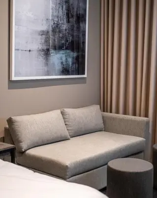 a living room with a couch and a bed at Menlyn Maine Trilogy Apartment in Pretoria