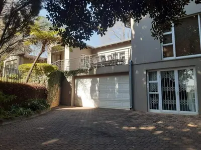 a large white house with a garage at Villa at 185 Milner Street in Pretoria
