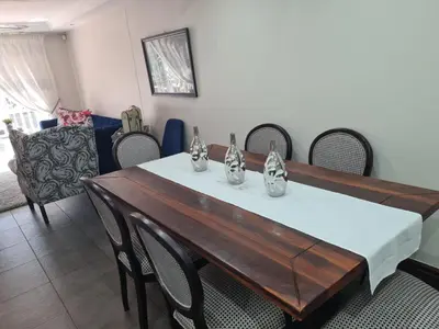 a dining room with a table and chairs at Villa at 185 Milner Street in Pretoria