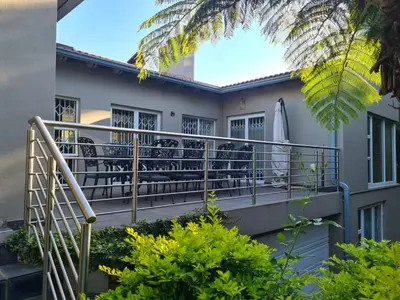 a balcony of a house with a surfboard on it at Villa at 185 Milner Street in Pretoria