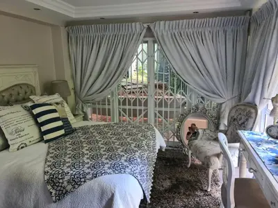 a bedroom with a bed and a window at Villa at 185 Milner Street in Pretoria